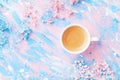 Cup of coffee and flowers on colorful table top view. Flat lay style. Creative breakfast for Woman day. Punchy pastel. Royalty Free Stock Photo