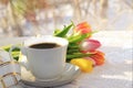 Cup of coffee and flowers in festive ribbon