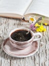 Cup of coffee and flowers in open book Royalty Free Stock Photo