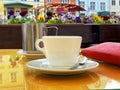 Cup of coffee  and flowers on table top in street cafe in summer Tallinn old town people lifestyle travel to Europe Royalty Free Stock Photo