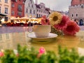 Cup of coffee and flowers table top in Tallinn old town medieval city stree town hall square