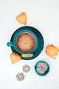 A cup of coffee with foam and a plate with heart-shaped shortbread cookies on a white table Royalty Free Stock Photo