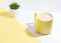 Cup of coffee with foam and succulent flower