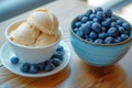 Cup of coffee fresh blueberries and bowl of homemade peanut ice cream Royalty Free Stock Photo