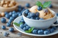 Cup of coffee fresh blueberries and bowl of homemade peanut ice cream Royalty Free Stock Photo
