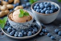 Cup of coffee fresh blueberries and bowl of homemade peanut ice cream Royalty Free Stock Photo