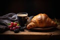 a cup of coffee and a fresh croissant, berries and coarse cloth, still life on a dark background Royalty Free Stock Photo