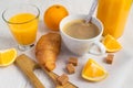 A cup of coffee, fresh oranges, orange juice and croissant Royalty Free Stock Photo