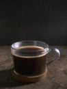 Cup of coffee with fume on the wooden background