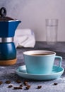 A cup of coffee and Geezer coffee maker under blurred bokeh background Royalty Free Stock Photo