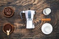 Cup of coffee, geyser coffee maker, milk and beans coffee on ,bleck wooden table. top view Royalty Free Stock Photo