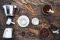 Cup of coffee, geyser coffee maker, milk and beans coffee on, dark wooden table. top view Royalty Free Stock Photo