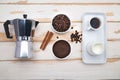 Cup of coffee, geyser coffee maker, milk and beans coffee on ,white wooden table. top view Royalty Free Stock Photo