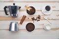 Cup of coffee, geyser coffee maker, milk and beans coffee on ,white wooden table. top view Royalty Free Stock Photo