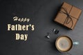 Cup of coffee, gift box and cuff links on table, flat lay. Happy father`s day Royalty Free Stock Photo