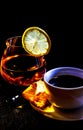 Cup with coffee and a glass with cognac and a slice of lemon