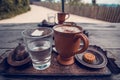 Cup of coffee, a glass of water and cookies on the wooden table. Royalty Free Stock Photo