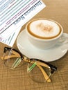 A cup of coffee, glasses and business newspaper Royalty Free Stock Photo