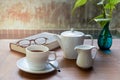 Cup of coffee and glasses on top of readbook on wood table. Royalty Free Stock Photo