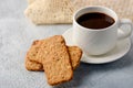 A cup of coffee with gluten-free cookies from cereals on the coffee table. Time have a bite Royalty Free Stock Photo