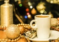 Cup of coffee and gold Christmas decorations Royalty Free Stock Photo