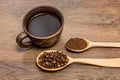 Cup of coffee, grain of coffee and ground coffee in wooden spo Royalty Free Stock Photo