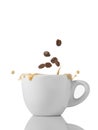 Cup of coffee with grains and splash on white Royalty Free Stock Photo