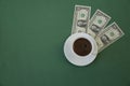 Cup of coffee on a green background with dollar bills. Three dollars. Coffee concept. Menu, background.