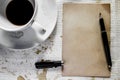 Cup of coffee with grunge notepad and pen