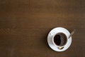 Cup of coffee on a grunge wooden table background