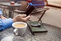 Cup of coffee and hand of man with a cellular telephone for Your advertisement text message Royalty Free Stock Photo