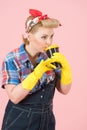 Cup of coffee in hands of girl with blonde curls. Pin-up style and craft cup of coffee. Woman drinks coffee in latex gloves