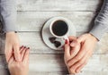 A cup of coffee in the hands of lovers. Silhouette in a cup. Royalty Free Stock Photo