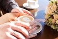 Cup of coffee and hands newlywed