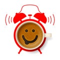 Cup of coffee with happy smiling face and silhouette of alarm clock