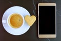 A Cup of Coffee and Heart Shaped Cookie with Empty Screen Mobile Phone on Black Mable Teble Royalty Free Stock Photo