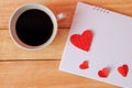 Cup of coffee and hearts on a wooden background. Coffee on calendar. valentine day with coffee concept.