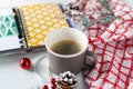 Cup of coffee, holiday decorations, cone and notebook, christmas planning concept. Happy new year