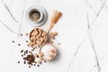 Cup of coffee with ingredients: bowls of brown cane lump and granulated white sugar, crystal sugar sticks and coffee beans