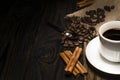 Cup of coffee and ingredients on a wooden background
