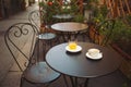 A cup of coffee and juice on table, in italian street, mediterranean style.