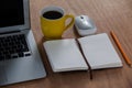 Cup of coffee with laptop, organizer, pencil and mouse Royalty Free Stock Photo