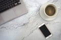 Cup of coffee , laptop and a phone, with marble background