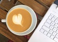 Cup of coffee and laptop on the table Royalty Free Stock Photo