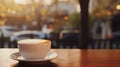 Cup of coffee with latte art and steam on wooden table on blurred background Royalty Free Stock Photo