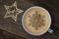 Cup of coffee latte art on wood table. Foam form of star and woo Royalty Free Stock Photo