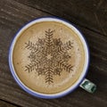 Cup of coffee latte art on wood table. Foam form of star and woo Royalty Free Stock Photo