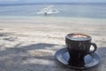 Cup of coffee latte on the beach