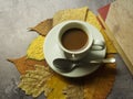 A cup of coffee and leaves
