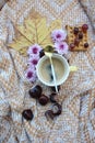 A cup of coffee with leaves and flowers